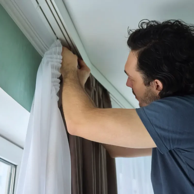 person-is-actively-hanging-beautiful-curtains-bright-cheerful-room-space-Large